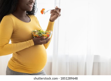 Closeup Of Unrecognizable Pregnant Black Lady Eating Fresh Salad, Copy Space. Expecting African American Woman Eating Vegetables During Pregnancy, Nutrition During Carrying Child Concept