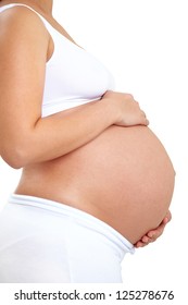 Close-up of unrecognizable pregnant woman with hands over tummy at white background