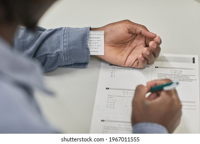 Closeup Of Unrecognizable Student Hiding Cheat Note While Taking Exam In School, Copy Space