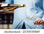 Close-Up of Unrecognizable Wine Expert Pouring White Wine Into Glass in Cellar