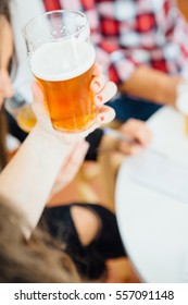 Close-up Of Unrecognizable Woman Holding Glass Of Light Craft Beer.From Above