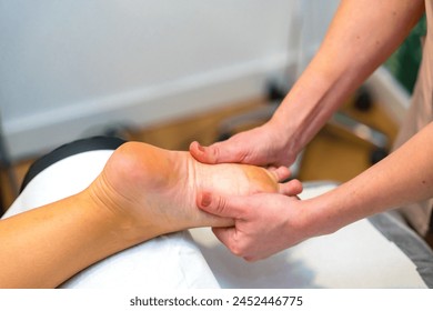 Close-up of an unrecognizable woman receiving a foot massage in the clinic - Powered by Shutterstock