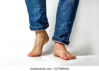Closeup of unrecognizable young caucasian man feet and wearing denim jeans pants isolated on white background - Powered by Shutterstock