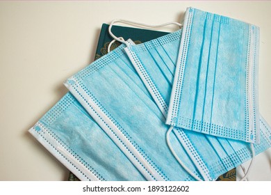 A closeup of unused protective mask on a notebook - COVID-19 concept - Shutterstock ID 1893122602