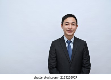 Close-up Of Upper Body Of Asian Male Office Worker, Serious Face, White Background