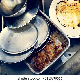 Closeup Of Used Dishes And Trays In Restaurant Kitchen Sink