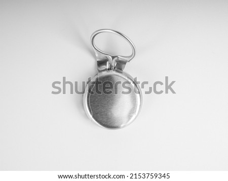 Close-up used silver ring pull bottle cap of glass bottle with blank space on the cap isolated on white background, top view. 