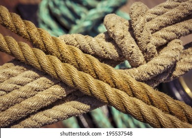 Close-up Of Used Vintage Marine Ropes With Nautical Knot On Old Sailing Vessel.