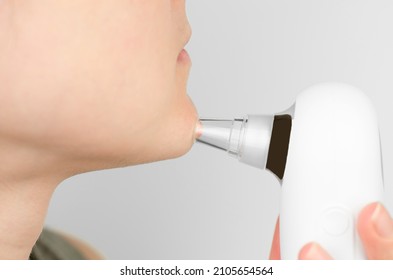 Close-up Of Using A Facial Blackhead Removal Machine. Cosmetic Facial Cleansing With A Blackhead Remover