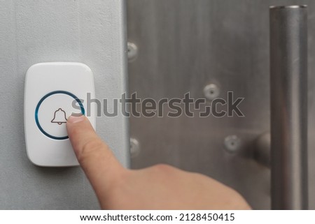 Close-up of using intercom  Hand presses the doorphone button 