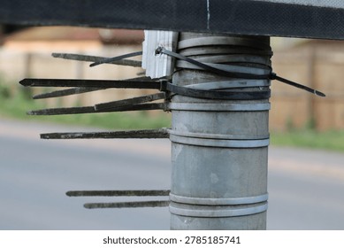 Close-Up Of Utility Pole Wrapped With Cable Ties And Zip Ties After Makeshift Repairs