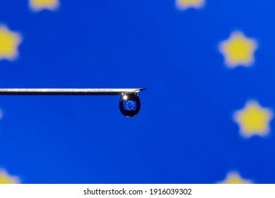 Close-up Of Vaccine Drop With EU Flag On Syringe Needle With Copy Space.