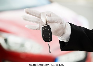 Close-up Of A Valet Boy Hand Holding Car Key Outside The Car