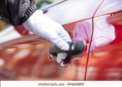 Close-up Of A Valet's Hand Opening Red Car Doors