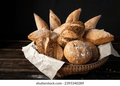 Close-up of a variety of freshly baked brown bakery items, fragrant, delicious, homemade, nutritious and healthy. In a basket on the kitchen floor. - Powered by Shutterstock