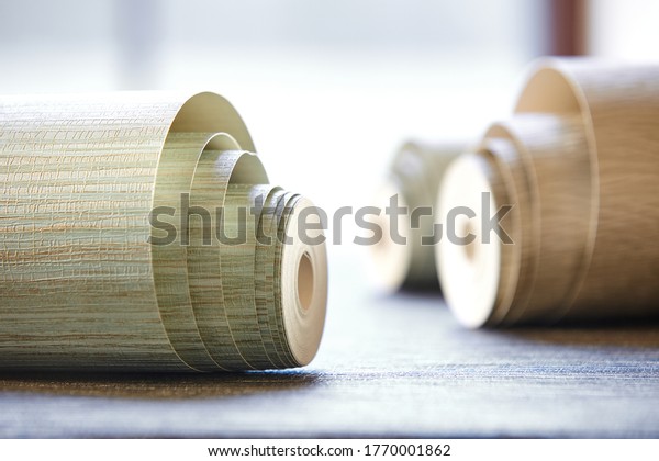 Close-up of variety of wallpaper rolls on floor in\
a store
