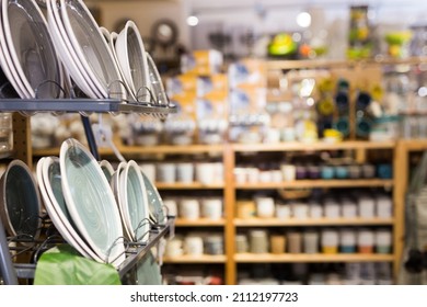 Closeup of various ceramic plates for sale in tableware department of home furnishings store - Shutterstock ID 2112197723