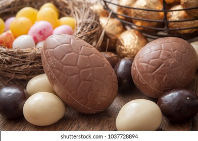 closeup of various chocolate easter egggs on wooden background