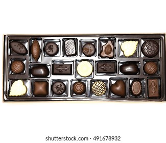 Close-up Various Chocolate Pralines Isolated On White. Sweet Food Background. Assortment Of Fine Belgium White, Dark, And Milk Chocolates. Overhead Tray With Selection Of Luxury Praline Box.