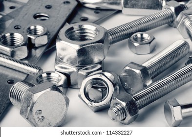 Close-up of various steel nuts and bolts - Shutterstock ID 114332227