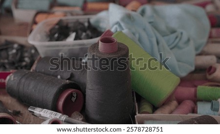 Similar – Image, Stock Photo Vibrant orange yarn spools in industrial setting