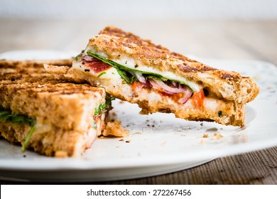 Close-up of vegetarian panini with tomatoes and mozzarella. Selective focus.