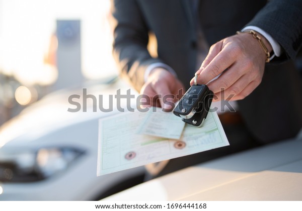 Close-up\
of vehicle papers and car keys, car\
purchase\
