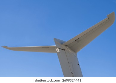 Close-up of vertical stabilizer and horizontal stabilizer junction with visible static discharge wicks