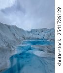 Close-up of vibrant blue meltwater pool on Perito Moreno Glacier in Argentina, showcasing the glacier