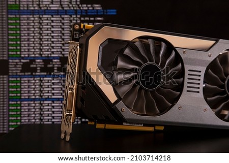 close-up video card with command line running on background showing cryptocurrency mining