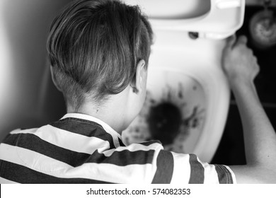 Close-up View From Above Of Incognito Teenager Kneeing Down Over Toilet Bowl And Vomiting