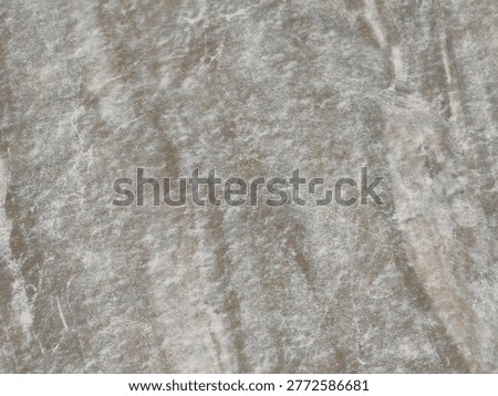 A close-up view of an abstract textured surface, showcasing a blend of subtle green, grey, and brown hues.