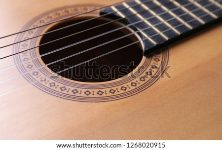 Closeup view of acoustic guitar, focus on sound hole