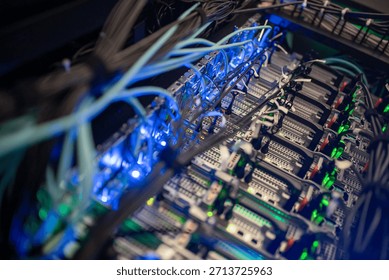A close-up view of an advanced computer server rack filled with network cables and illuminated components, showcasing modern technology in a data center environment.