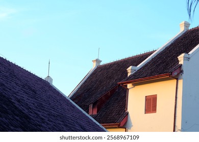 Close-up view of aged building rooftops at sunset, showcasing the intricate details of the architecture.