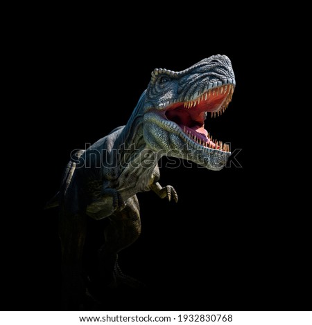 Closeup view of an angry T-Rex dinosaur figurine on black background. Monstrous animal with open mouth and sharp teeth