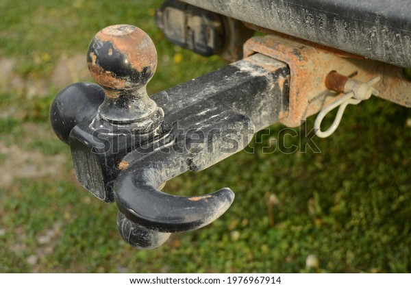 A closeup view of an attached trailer hitch\
on a vehicle for towing loads\
behind.