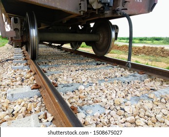 A Closeup View Of The Axle And Wheels At The Lower End Of The Railway Wagon Passing Over Newly Build Train Track
