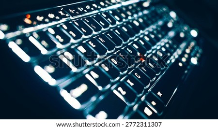 A close-up view of a backlit computer keyboard illuminated with bright white light in a dark setting, featuring a distinctive red trackpoint. Glowing keys, technology hardware, red pointing stick, computer typing, night workplace. Modern style, dark office environment, low-angle perspective view.