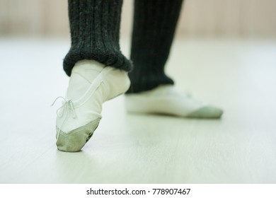 Closeup View Of Ballerina's Legs In Pointe. She Stretching Tip Toe In Danse Gym. Dance School Concept