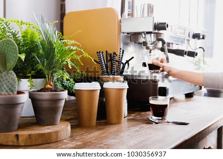 Close-up view of bartender preparing coffee on modern espresso machine