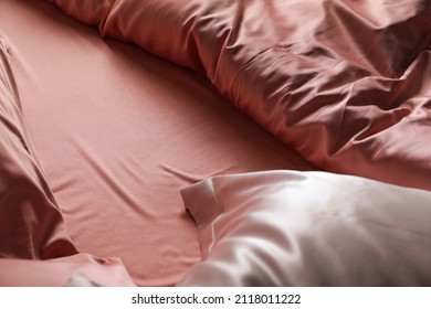 Closeup view of bed with beautiful silk linens - Shutterstock ID 2118011222