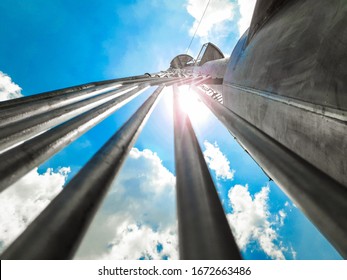 Close-up View From Below To The Top Of Flare Stack Tower In LNG Facility On Cloudy Day