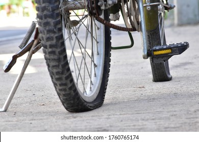 Closeup View Of Bicycle Flat Tires On Pavement.