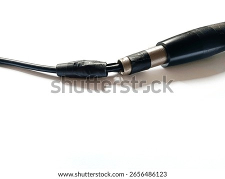 close-up view of a black audio cable with a male XLR connector, showing exposed wires and insulation taped together with black electrical tape, indicating damage or a makeshift repair.