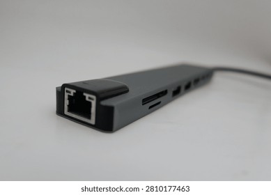 Close-up view of a black computer peripheral with multiple ports against a clean white background.