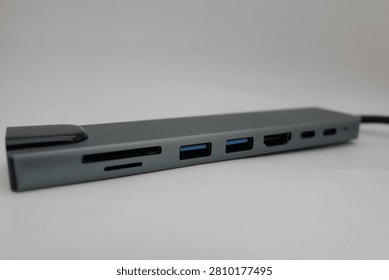 Close-up view of a black computer peripheral with multiple ports against a clean white background.