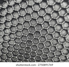Close-up view of a black hexagon shape, highlighting its sharp edges and smooth surface.