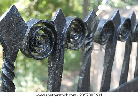 Closeup View of Black Iron Cemetery Gate.