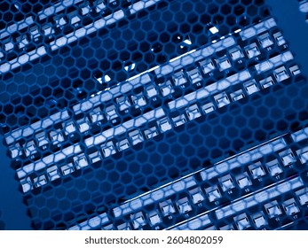 Close-up view of a blue hexagonal pattern showcasing server components. The image highlights modern technology and electronic connectivity within an industrial context.